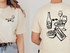 Dinner Club Unisex t-shirt, light tee, aesthetic graphic tee, wine shirt, gift for her Capturing a vibey night with the best company, sipping wine in low light. What a vibe! The perfect gift for the wine lover in your life This t-shirt is everything you've dreamed of and more. It feels soft and lightweight, with the right amount of stretch. It's comfortable and flattering for all.  * 100% combed and ring-spun cotton * Fabric weight: 4.2 oz/yd² (142 g/m²) * Pre-shrunk fabric * Side-seamed constru Restaurant T Shirt Design, Wine Club Aesthetic, Graphic Tee Aesthetic, Funky Graphic, Wine Tshirts, Dinner Club, Wine Shirt, Food Shirt, Aesthetic Shirt