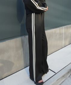 Jersey pants with side lines.
 
The flared pants also make your legs look longer.


 size

 Elastic waist 60cm+

 Hips 92cm

 Rise 33.5cm

 Inseam 65cm


 ■ Country of Origin: China

 ■Material: 95% polyester, 5% polyurethane Chic Black Bottoms With Contrast Stripes, Black Trousers With Contrast Stripes, Black Wide-leg Pants With Contrast Stripes, Black Wide Leg Pants With Contrast Stripes, Black Bottoms With Contrast Stripes For Workwear, Black Bottoms With Contrast Stripes For Work, Fitted Black Pants With Contrast Stripes, Black Full-length Bottoms With Side Stripes, Full Length Pants With Side Stripes