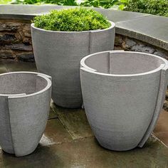 three cement planters sitting next to each other