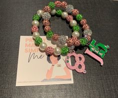 7.5 inch handmade bracelet1. 08 2.J15Price per bracelet $15.00 Handmade Bangle Bracelets For Birthday, Handmade Green Bracelets For Birthday Gift, Handmade Green Bracelets For Birthday, Green Handmade Bracelet For Birthday, Girly Bracelets, Blow Dry Bar, Divine Nine, Diy Beaded Bracelets, Pink Mask