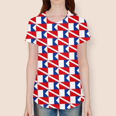 a woman wearing a red, white and blue t - shirt with an arrow pattern