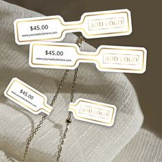 three price tags are attached to a white chair with chains on it and the price is $ 45 00