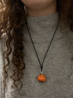 This is a pumpkin necklace made with Polymer Clay. It comes with an adjustable, black necklace cord. This product is handmade by me so each pumpkin is unique and not the exact same as any other. Great for the fall season! Handmade Casual Halloween Jewelry, Casual Handmade Halloween Jewelry, Casual Handmade Jewelry For Halloween, Casual Halloween Jewelry Gift, Adjustable Necklace For Halloween Gift, Adjustable Halloween Necklace Gift, Adjustable Halloween Necklace For Gift, Handmade Adjustable Jewelry For Fall, Adjustable Handmade Jewelry For Fall