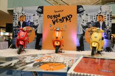 three mopeds are on display in front of a sign that says do you vespa?