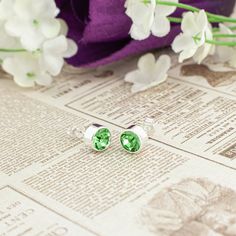 Give the ultimate gift of style with this exquisite pair of 14K gold plated or silver plated crystal earrings. Both earrings are adorned with a 6mm radiant Bohemian crystal in a lustrous light green, like the stone Peridot, the August birthstone. The perfect embodiment of elegance and sophistication. The easy butterfly push on backings make it ideal for everyone, from little girls and teens to adults.  Here are some details you might appreciate: MATERIAL & COLOR: The stud earrings are crafted from high quality 14k gold or silver plated metal, giving it a rich, glossy and lustrous appearance.   EARRING DESIGN: The Bohemian crystal is housed in solid bezel setting with an enclosed back to enhance the crystal's high reflection and shield it from dirt. These earrings have standard 10mm length Silver Cubic Zirconia Earrings For Birthday, Silver Cubic Zirconia Birthday Earrings, Green Crystal Earrings For May Birthstone Anniversary, Round Cubic Zirconia Earrings For Birthday, Green Crystal Earrings For Anniversary, Green Crystal Earrings For May Birthstone Gift, Green Earrings For Anniversary, May Birthstone, Classic Earrings For May Birthstone Gift, Green Crystal May Birthstone Earrings For Gift