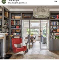 a living room filled with lots of books and furniture