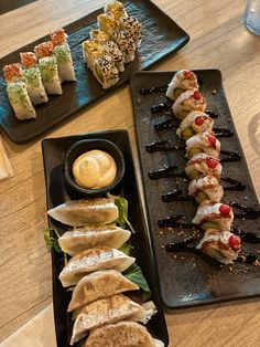 sushi platters with different types of food on them