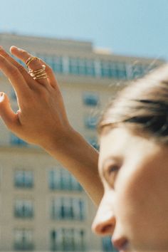 a woman holding her hand up to the sky