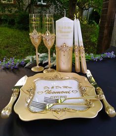 a table set up with champagne glasses, silverware and napkins