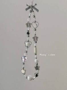 a white necklace with charms hanging from it's side