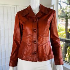 Mannequin 4 Vintage 1970's Abacus Women's Leather Button Up Notch Collar Lined Jacket W/Piping. Good Condition. Lined. Fitted. Usa; 0 / 2 Shoulders; 15.5 Chest; 17.5 Waist; 15.5 Sleeve Length; 22.5 Total Length; 22.5 Fitted Leather Jacket With Buttons For Fall, Fitted Leather Jacket With Snap Buttons For Fall, Fitted Leather Jacket With Button Closure For Fall, Spring Fitted Leather Jacket With Button Closure, Fitted Leather Jacket With Buttons For Spring, Fitted Retro Leather Jacket For Workwear, Leather Button Up, Coats Vintage, Collar Jacket