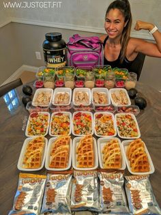 a woman sitting in front of a table filled with lots of waffles and other food