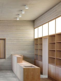 an empty room with wooden shelves and white walls