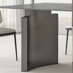 a modern dining table and chairs in a room with white carpeted flooring on the side