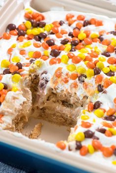 a cake that has been cut in half and is decorated with candy corn, chocolate chips, and marshmallows