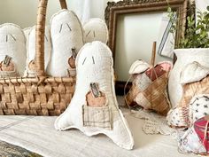 several decorative items are sitting on a table next to a basket and framed photo in the background