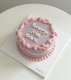 a birthday cake with pink frosting and writing on it that says happy birthday love