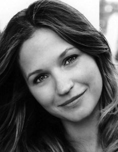 a black and white photo of a woman with long hair