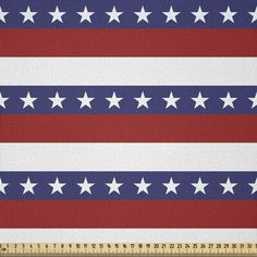 an american flag with white stars on red, white and blue stripes is shown in front of a ruler