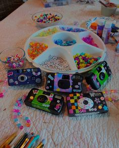 a table topped with lots of crafting supplies on top of a white table cloth