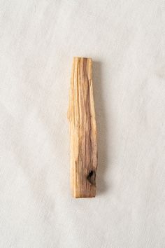 a piece of wood sitting on top of a white cloth