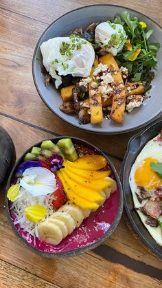 three plates with different types of food in them on a wooden table next to an eggplant and potato salad