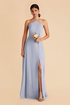 a woman in a blue bridesmaid dress holding a bouquet