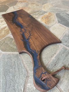 a wooden bench sitting on top of a stone floor covered in blue paint and wood