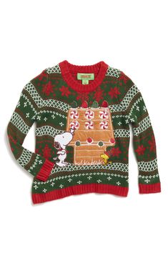 a green and red sweater with an image of a gingerbread house on the front