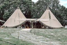 a large tent set up in the middle of a field