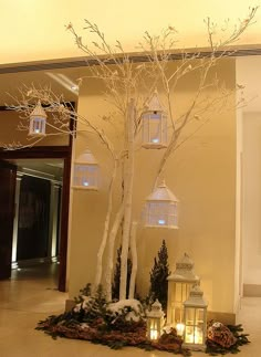 there is a lighted tree in the middle of this room with lanterns on it and candles lit up