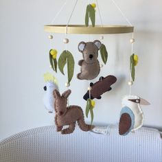 a crib with stuffed animals hanging from it's sides