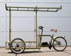 a green bike parked in front of a metal structure