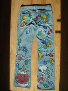 a pair of blue jeans with cartoon characters on them