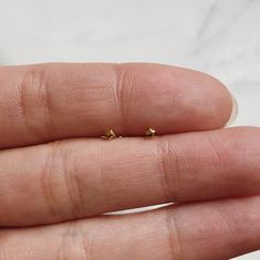 Teeny tiny minimalist star stud earrings-- looks great on its own or stacked with our other small studs! * 14k gold plating over sterling silver (hypoallergenic & nickel-free) * Matching post backing * Measures about 2mm * Ships as a pair (2 earrings total) Every order comes nicely packaged, ready for gift-giving! Please note that multiple items in the same order will be combined into one gift box. If the items are meant for separate individuals, please let me know. Also available in sterlin Basic Gold Earrings Studs, Cheap Minimalist Pierced Earrings, Gold Dainty Earrings Simple, Round Earrings With Tiny Beads, Cheap Tiny White Piercings, Cheap Delicate Tiny Cartilage Earrings, Cheap Nickel-free Dainty Piercings, Cute Small Cheap Earrings, Minimalist Earrings Studs Simple