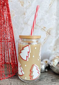 a glass jar filled with liquid next to christmas decorations