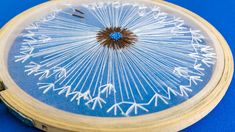 a blue and white clock sitting on top of a wooden frame with an intricate design