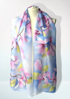 Hand panted silk scarf 'Magnolia Flowers' is a long silk scarves from delicate and light weight, decorated with magnolia flowers on a pastel baby blue skies. Size: about 61 by 17 in (155 by 43 cm) Silk: natural Habotai Light, which is a delicate, semi transparent fabric, with a glossy quality. Silk scarf 'Magnolia Flowers' is made to order! It will take me up to 3 days to paint a similar scarf, please note that I don't use patterns and the scarf for you will be unique and slightly different from Pink Silk Shawl For Spring, Pink Floral Print Silk Scarf, Pink Feminine Silk Scarf, Pink Silk Scarf With Floral Print, Pink Floral Print Silk Scarves, Pink Silk Shawl Scarf, Pink Silk Shawl Scarves, Pink Silk Scarf For Summer, Pink Silk Scarf For Spring