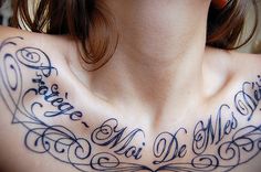 a woman's chest with some writing on it