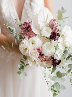 a bridal holding a bouquet of flowers and greenery