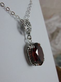 Red Garnet CZ Pendant Necklace, garnet pendant, with a deep red oval stone set in floral sterling silver filigree, 4 prongs hold the gem in place, Silver Embrace Jewelry Edwardian Necklace, Victorian Filigree, Antique Filigree, Filigree Jewelry, Garnet Pendant, Cz Pendant, Sterling Silver Filigree, Silver Filigree, Style Necklace