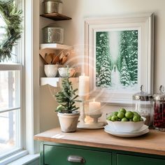 a kitchen counter topped with green fruit and candles