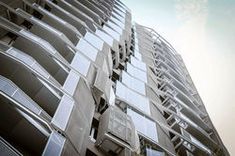 a tall building with lots of windows and balconies