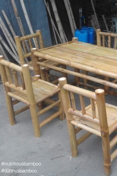 a wooden table and chairs sitting next to each other in front of a blue container