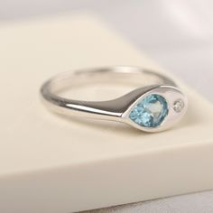 All HANDMADE ITEMS SHIP IN APPROX 8 DAYS Main Stone: Real Swiss blue topaz Main Stone Size: Pear cut 5 mm x 7 mm Main Stone Weight: 0.91 carat Side Stone: CZ Height From The Ring Setting Bottom(to gemstone top): about 4.25 mm Width of Ring band Measure: gradually varied,about 2.34 to 2.97 mm Material: 925 Sterling Silver/14K White Gold/14K Yellow Gold/14k Rose Gold Engraved: Available For FreeNo more than 13 letters) Customized:Of course! Tell me what you want Includes With Order: All of my stor Blue Topaz Gemstone Signet Ring Gift, Gift Blue Topaz Ring With Polished Finish, Minimalist Topaz Birthstone Ring, Blue Topaz Ring With Tension Setting For Promise, Modern Blue Topaz Birthstone Ring For Promise, Modern Blue Topaz Birthstone Promise Ring, Anniversary Blue Topaz Teardrop Ring, Anniversary Teardrop Blue Topaz Ring, Hallmarked Blue Topaz Birthstone Promise Ring