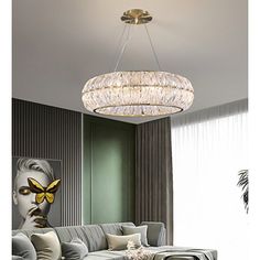 a living room filled with furniture and a large chandelier hanging from the ceiling