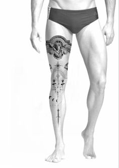 a man with tattoos on his legs and the bottom half of his body is shown