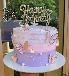 a birthday cake that has butterflies on it