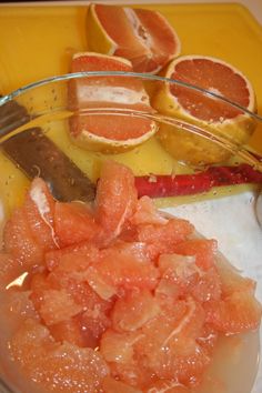 oranges and other fruits are in a glass bowl