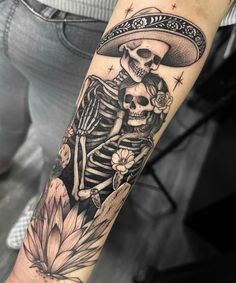 a woman's arm with a skeleton and mexican hat tattoo on the left forearm